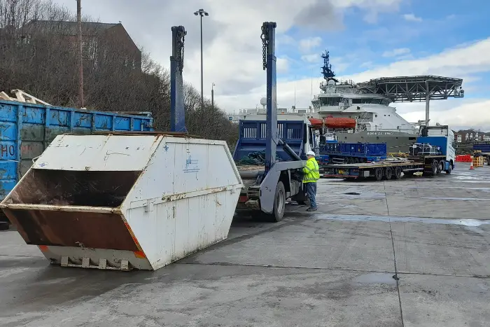 Enclosed skip delivered to port